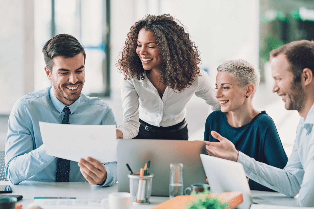 Group of professionals collaborating on a project in a modern office setting.